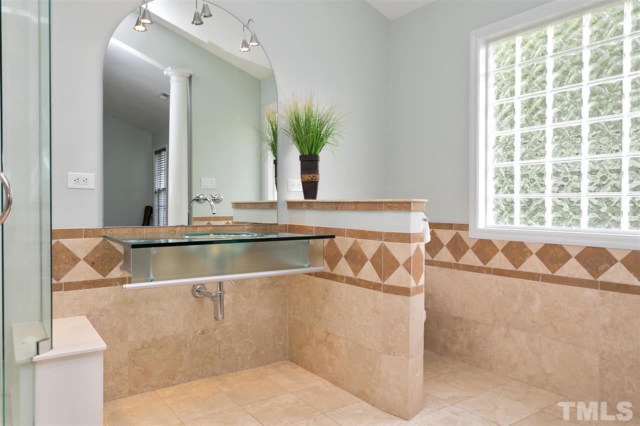 7314 Doverton Court Raleigh, NC 27615 - Photo 17 of 30 a view of bathroom sink and mirror