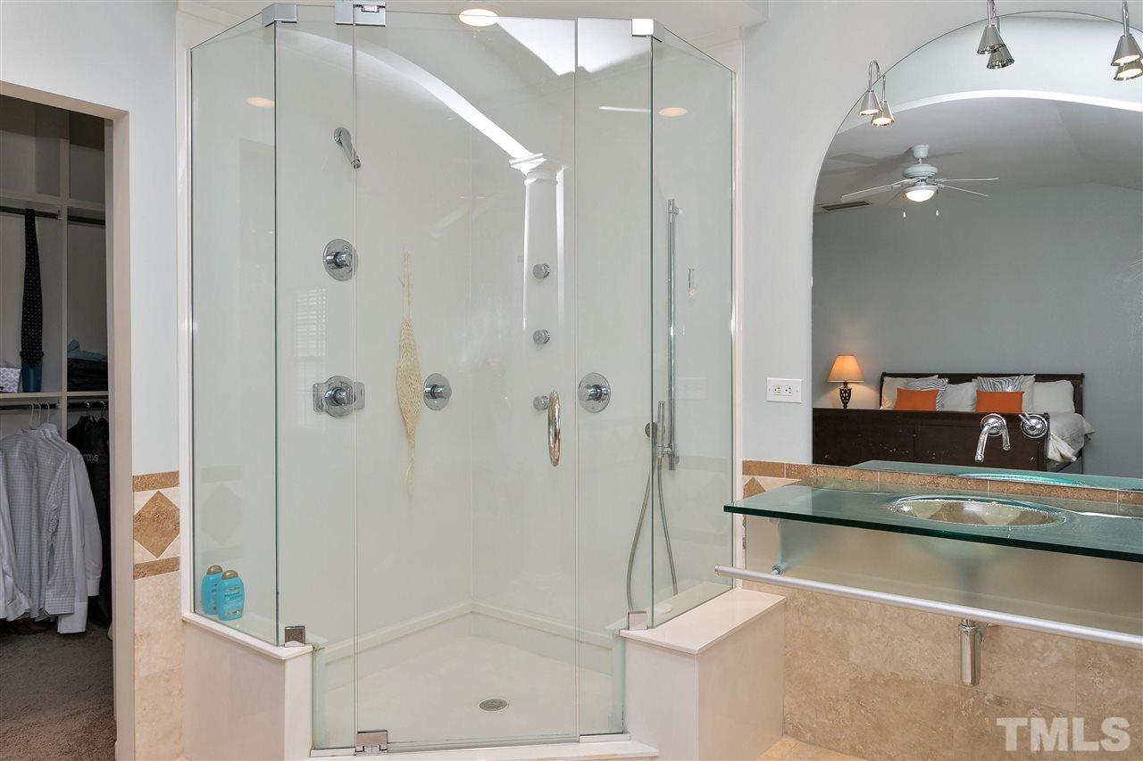 7314 Doverton Court Raleigh, NC 27615 - Photo 18 of 30 a bathroom with a mirror and a shower