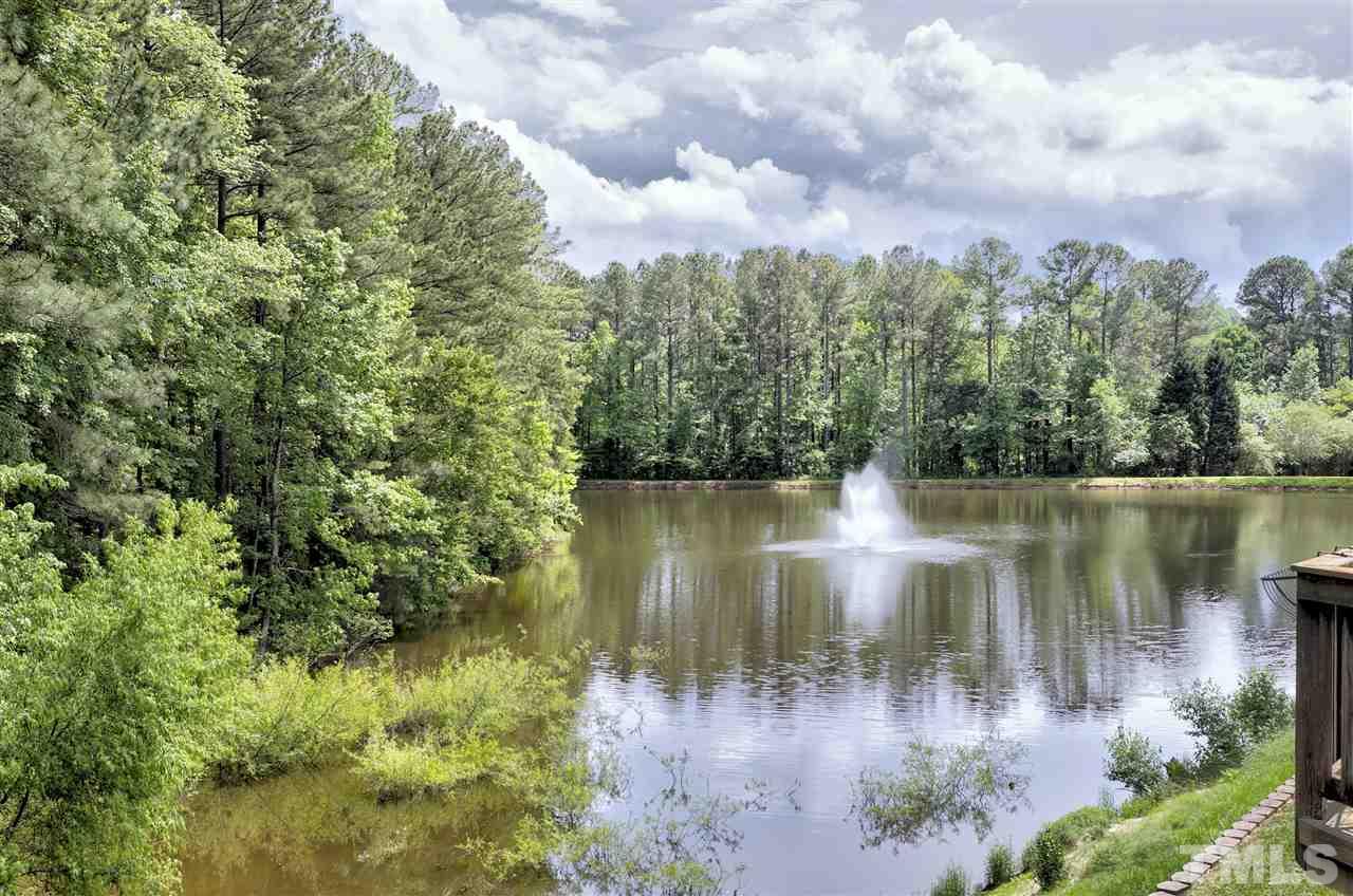 7314 Doverton Court Raleigh, NC 27615 - Photo 3 of 30 a view of a lake with green space