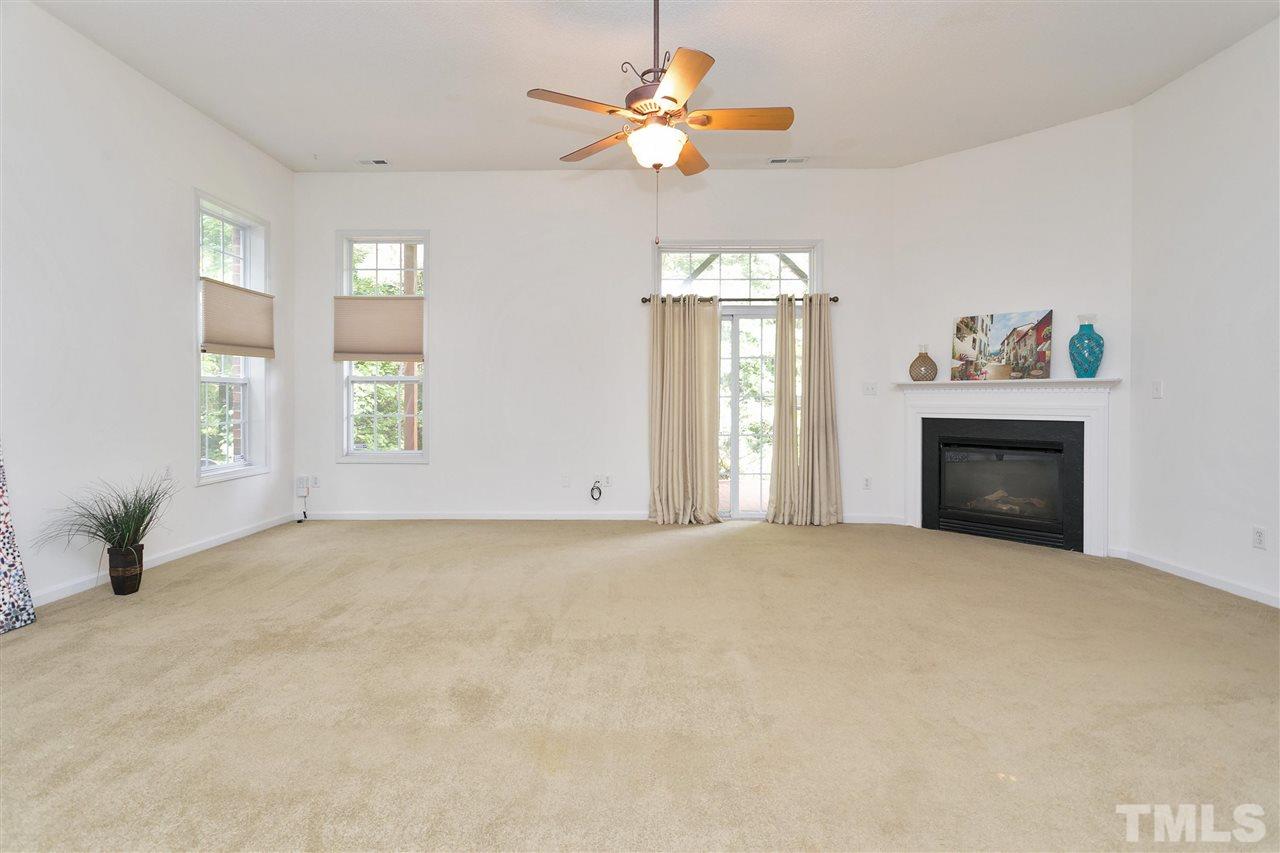 7314 Doverton Court Raleigh, NC 27615 - Photo 24 of 30 an empty room with windows and fireplace