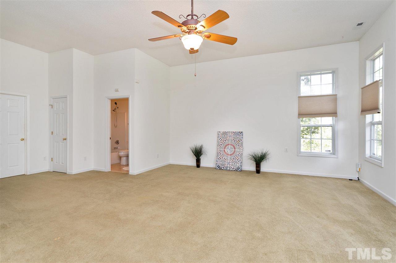 7314 Doverton Court Raleigh, NC 27615 - Photo 25 of 30 a big room with windows and ceiling fan