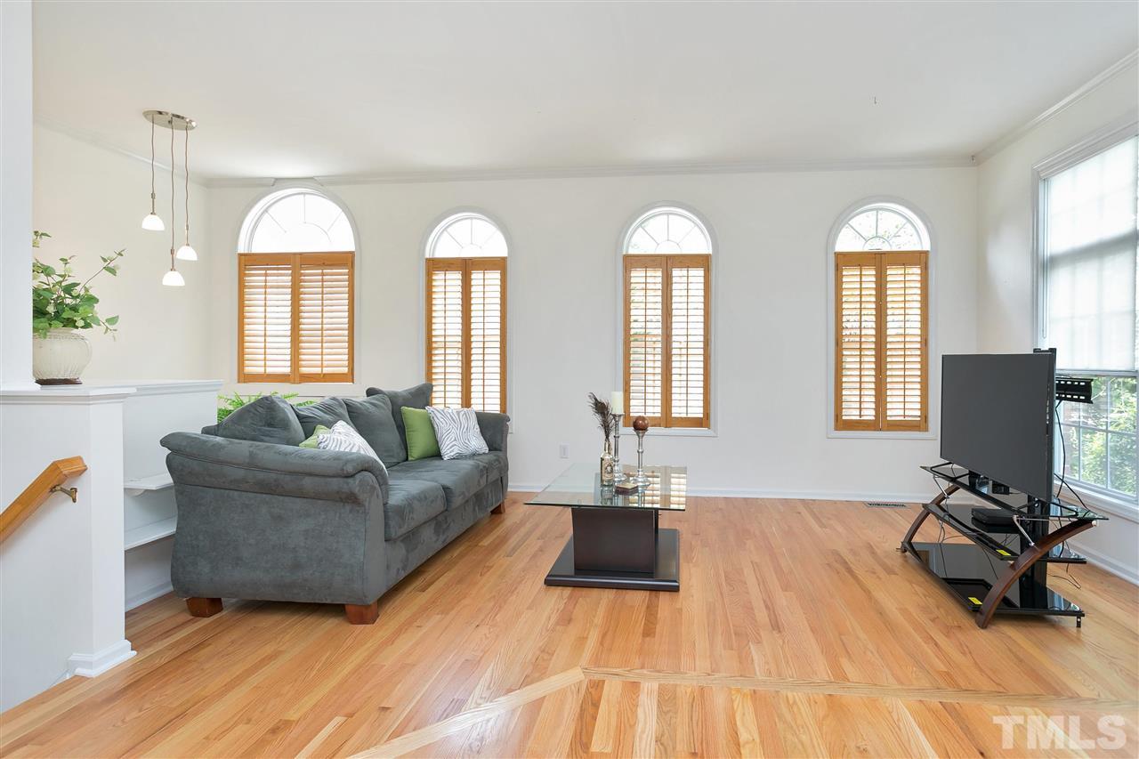 7314 Doverton Court Raleigh, NC 27615 - Photo 5 of 30 a living room with furniture and a large mirror next to a window