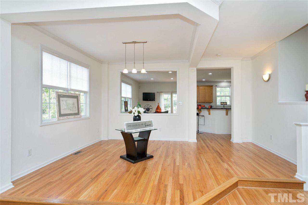 7314 Doverton Court Raleigh, NC 27615 - Photo 7 of 30 a view of a dining room and livingroom with furniture wooden floor a chandelier