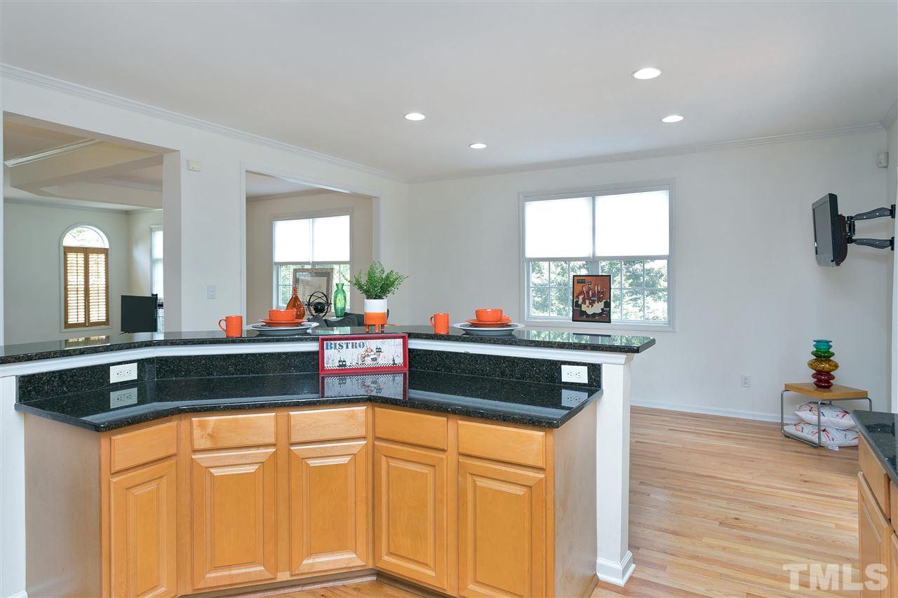 7314 Doverton Court Raleigh, NC 27615 - Photo 10 of 30 a kitchen with stainless steel appliances granite countertop a stove a sink and a refrigerator