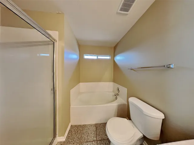 a white toilet sitting next to a bathroom sink and tub