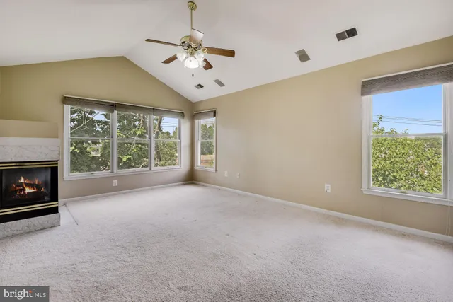 a view of an empty room with a fireplace