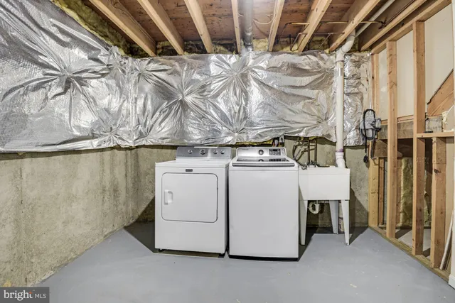 a view of a white house with a large windows and a yard