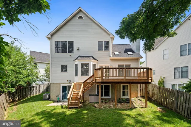 a view of a house with backyard and porch