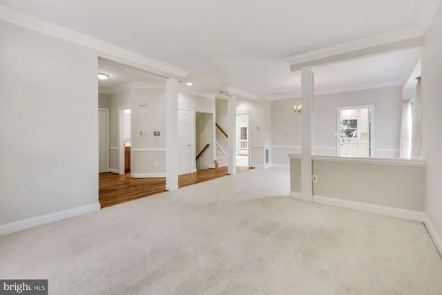 a view of an empty room with a kitchen