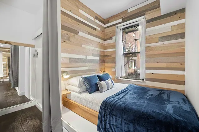 a bedroom with a bed and a window