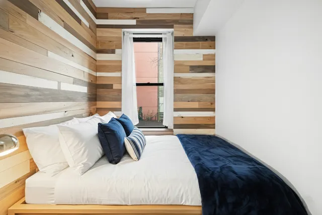 a bedroom with a bed and cabinets