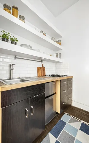a kitchen with cabinets and window