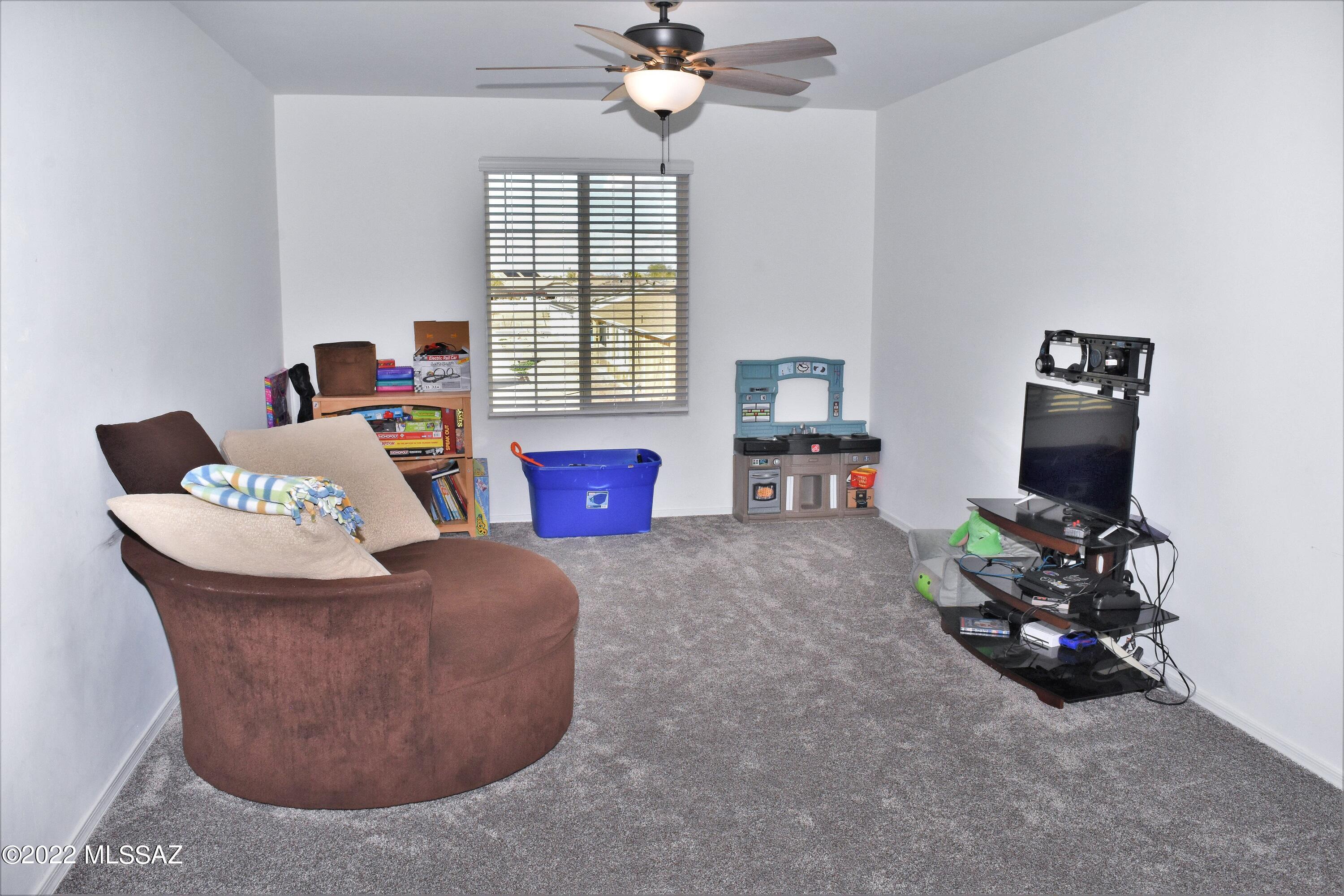21295 East Treasure Road Red Rock, AZ 85145 - Photo 13 of 34 a living room with furniture and a window