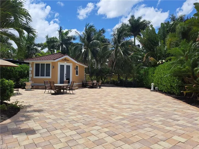 a view of a white house with a patio