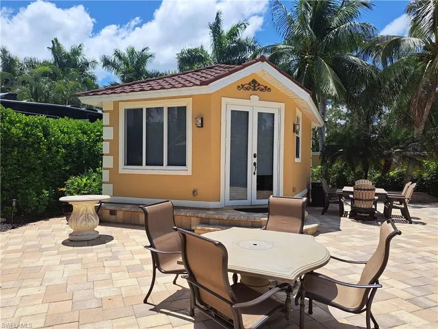 a view of a patio with table and chairs and potted plants