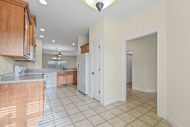a kitchen with a refrigerator sink and cabinets