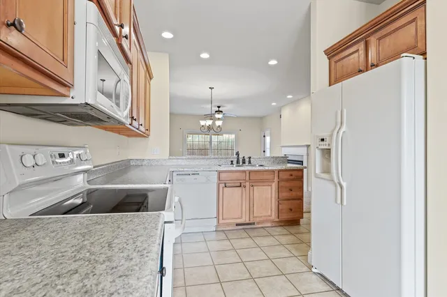 a kitchen with sink cabinets and chandelier