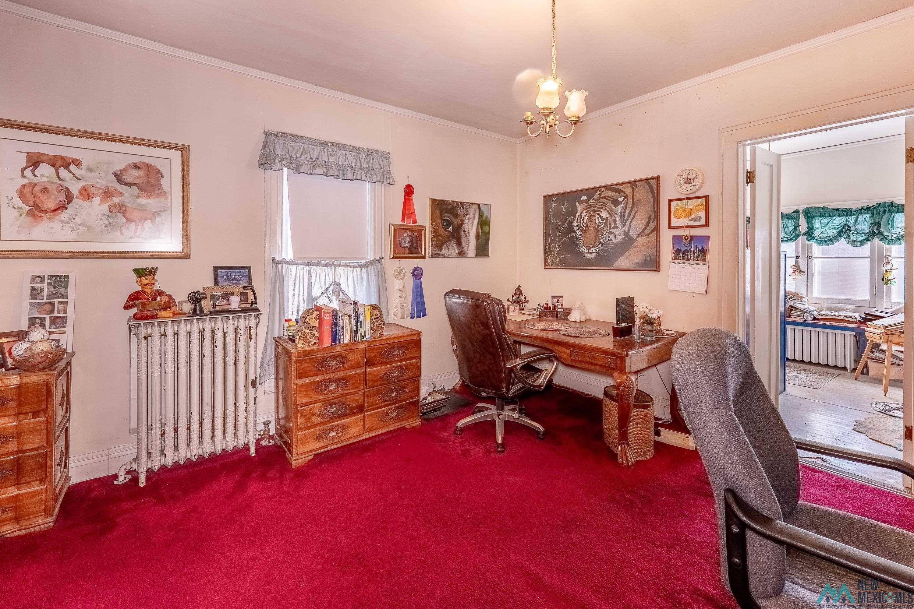 301 South 4th Street Raton, NM 87740 - Photo 27 of 78 Office area with ornamental molding, radiator, a chandelier, plenty of natural light, and carpet flooring