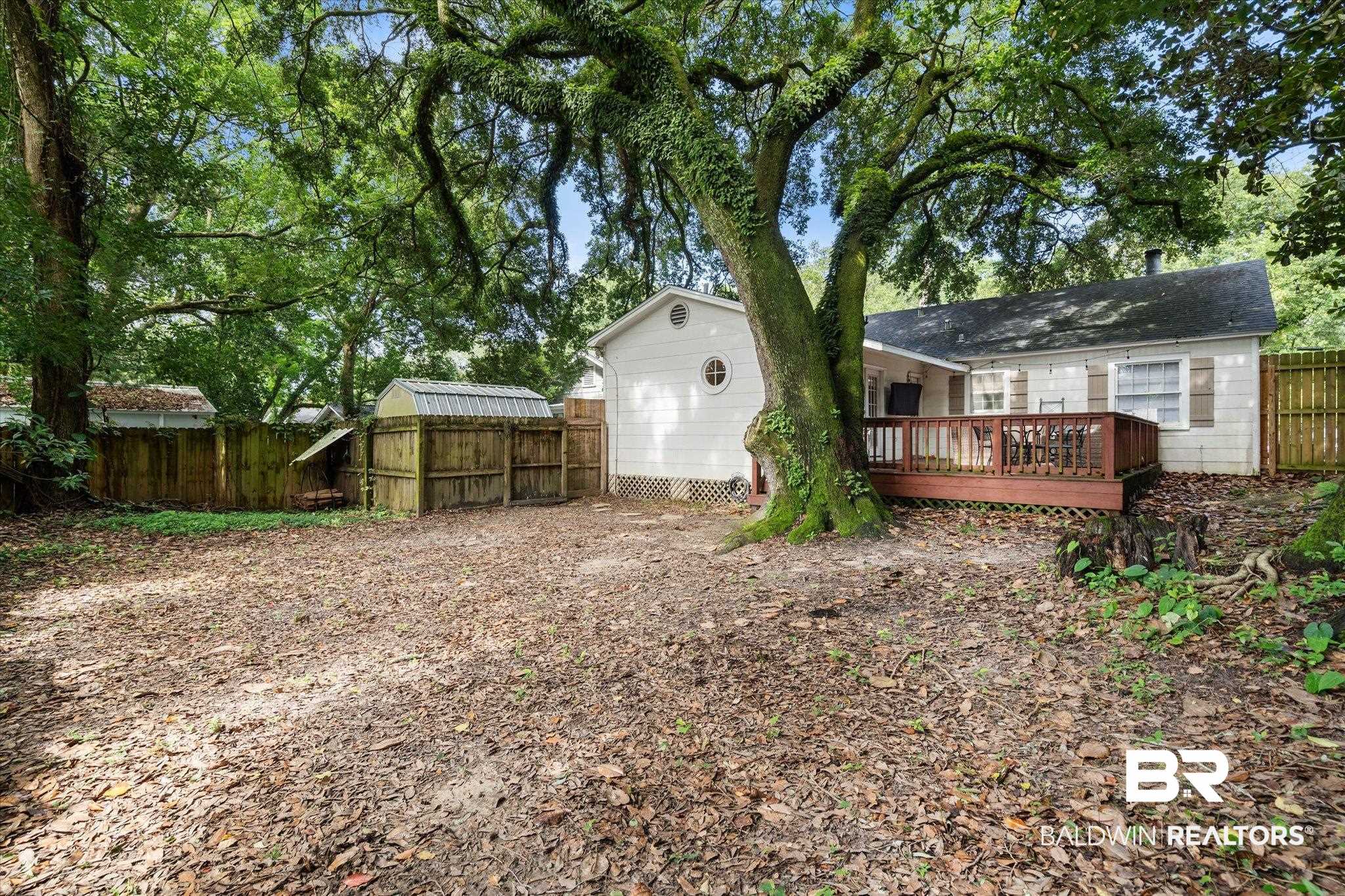 165 Crenshaw Street Mobile, AL 36606 - Photo 19 of 21 Back of house with a deck and a fenced backyard