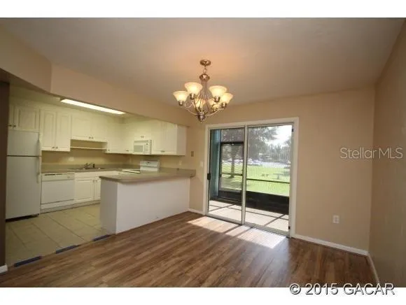 a view of a kitchen with wooden floor
