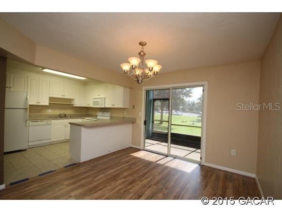 501 Southwest 75th Street, Unit J1 Gainesville, FL 32607 - Photo 4 of 12 a view of a kitchen with wooden floor
