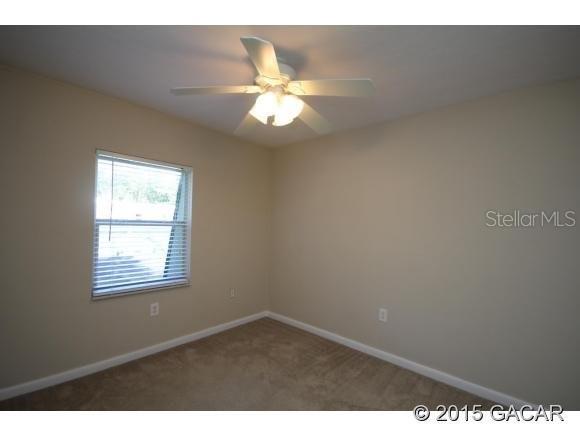 501 Southwest 75th Street, Unit J1 Gainesville, FL 32607 - Photo 8 of 12 a view of an empty room with a window