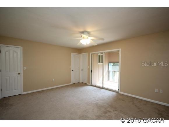 501 Southwest 75th Street, Unit J1 Gainesville, FL 32607 - Photo 10 of 12 a view of an empty room and a ceiling fan