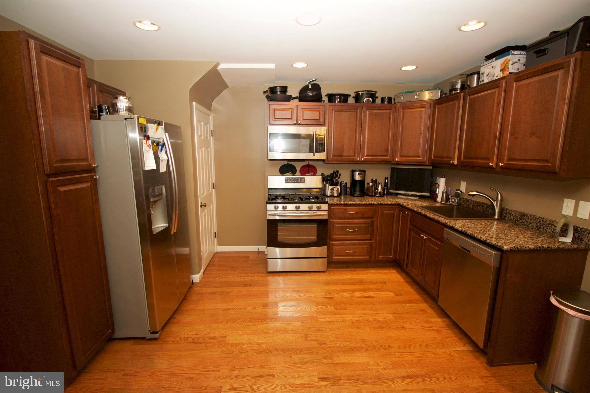 512 Old Riverside Road Baltimore, MD 21225 - Photo 11 of 38 a kitchen with stainless steel appliances a refrigerator and a sink