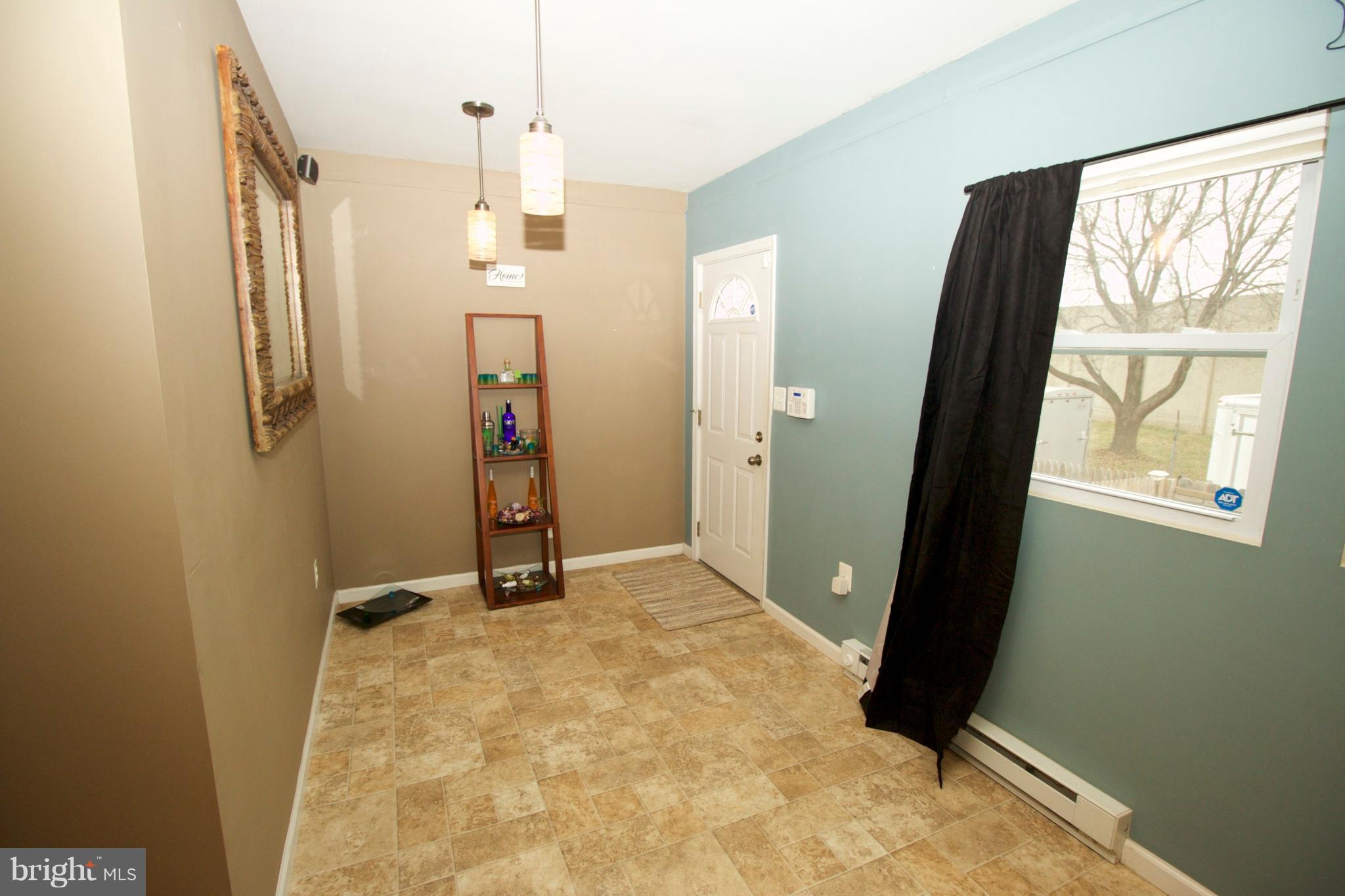 512 Old Riverside Road Baltimore, MD 21225 - Photo 16 of 38 wooden floor in an empty room with a window