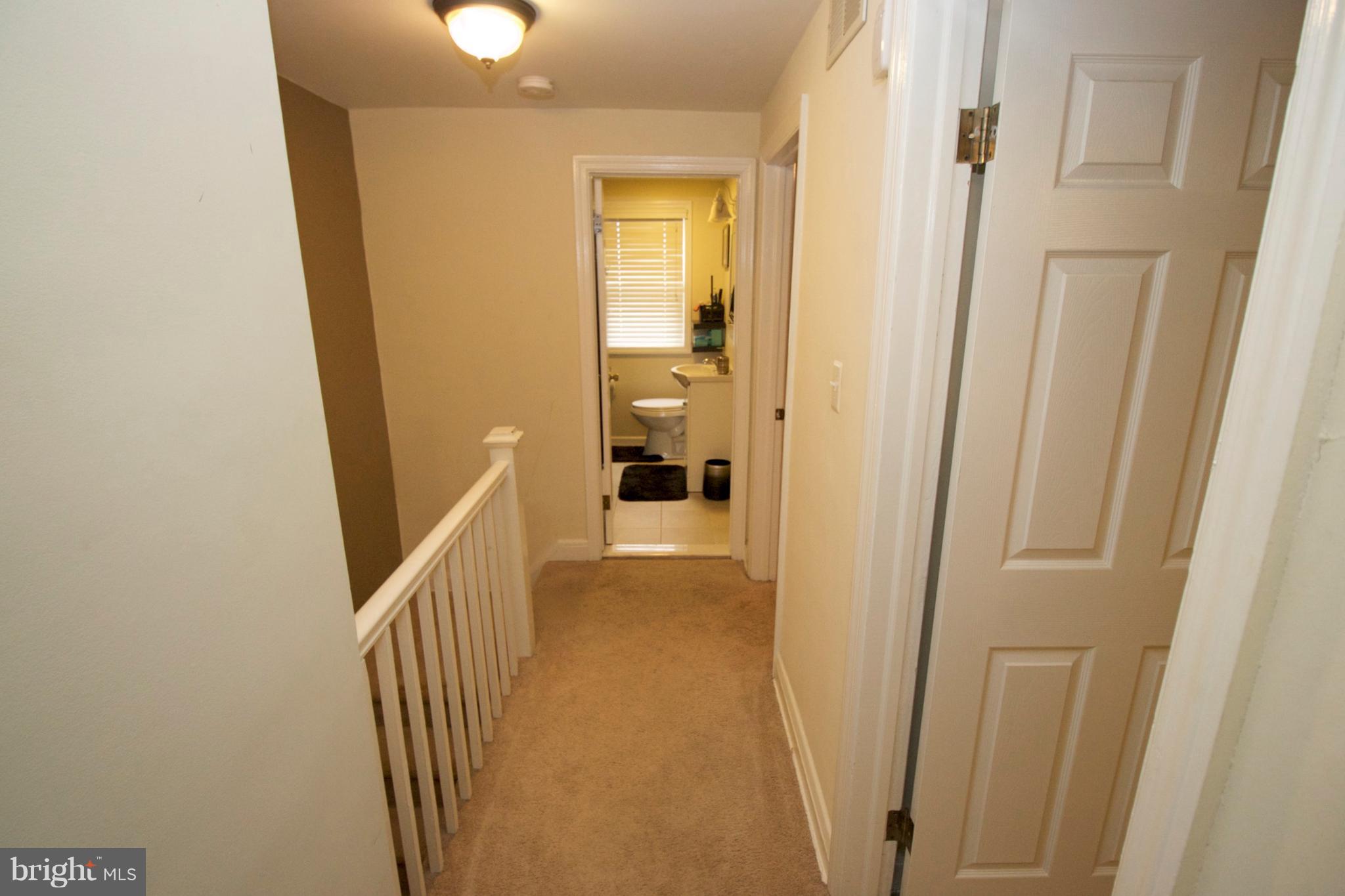 512 Old Riverside Road Baltimore, MD 21225 - Photo 20 of 38 a view of a hallway with wooden floor and stairs