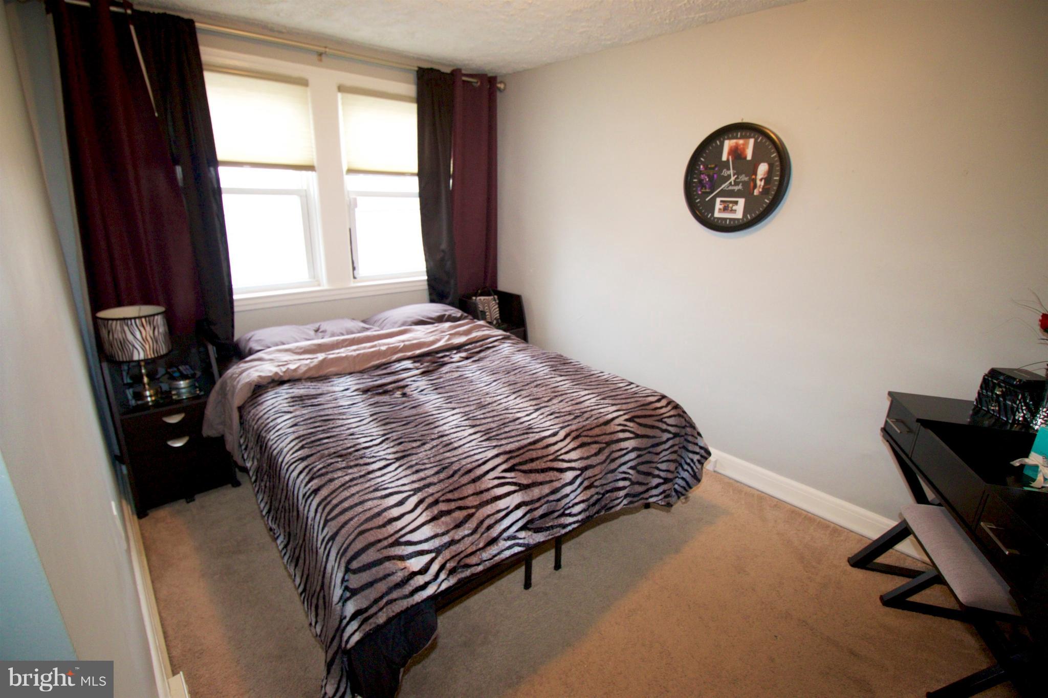 512 Old Riverside Road Baltimore, MD 21225 - Photo 23 of 38 a bedroom with a bed and a window