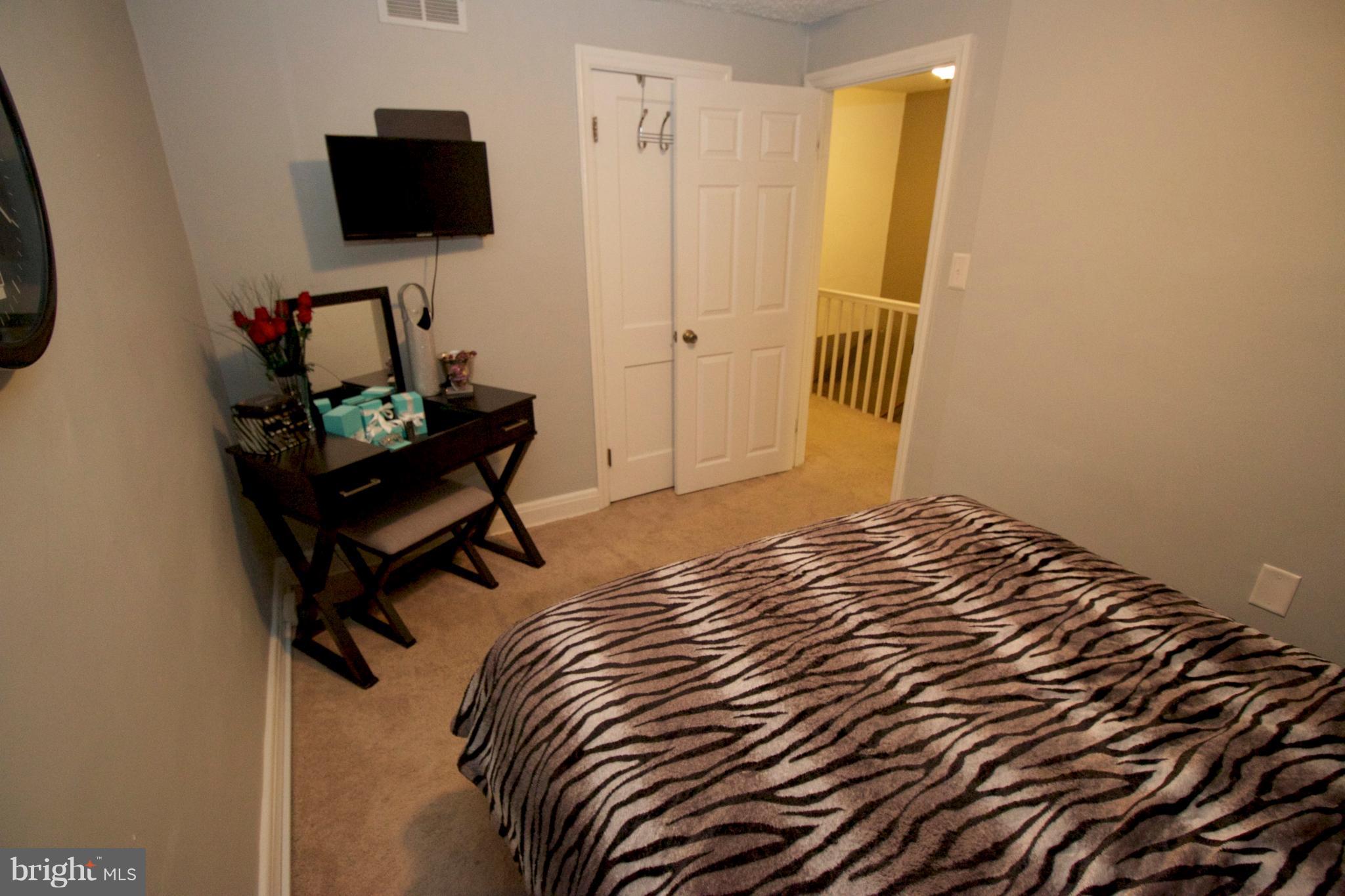 512 Old Riverside Road Baltimore, MD 21225 - Photo 24 of 38 a bedroom with a bed and a flat screen tv