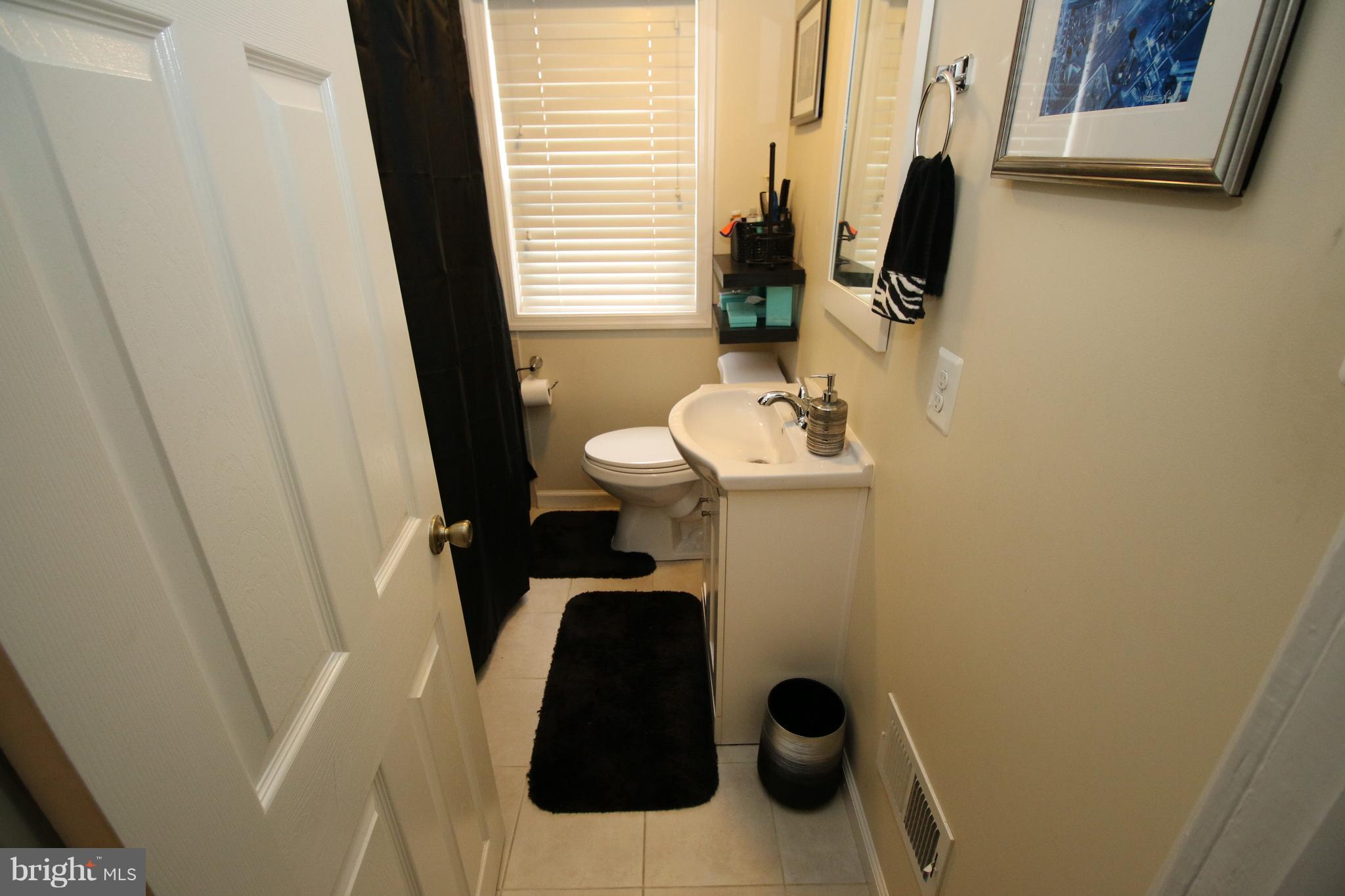 512 Old Riverside Road Baltimore, MD 21225 - Photo 27 of 38 a bathroom with a sink and toilet
