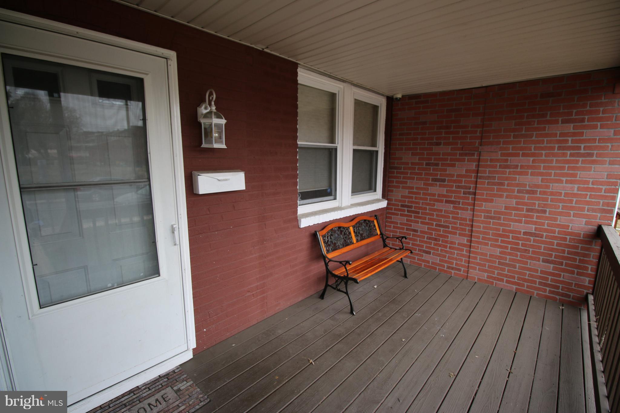 512 Old Riverside Road Baltimore, MD 21225 - Photo 3 of 38 a bench and bench sitting in front of a door
