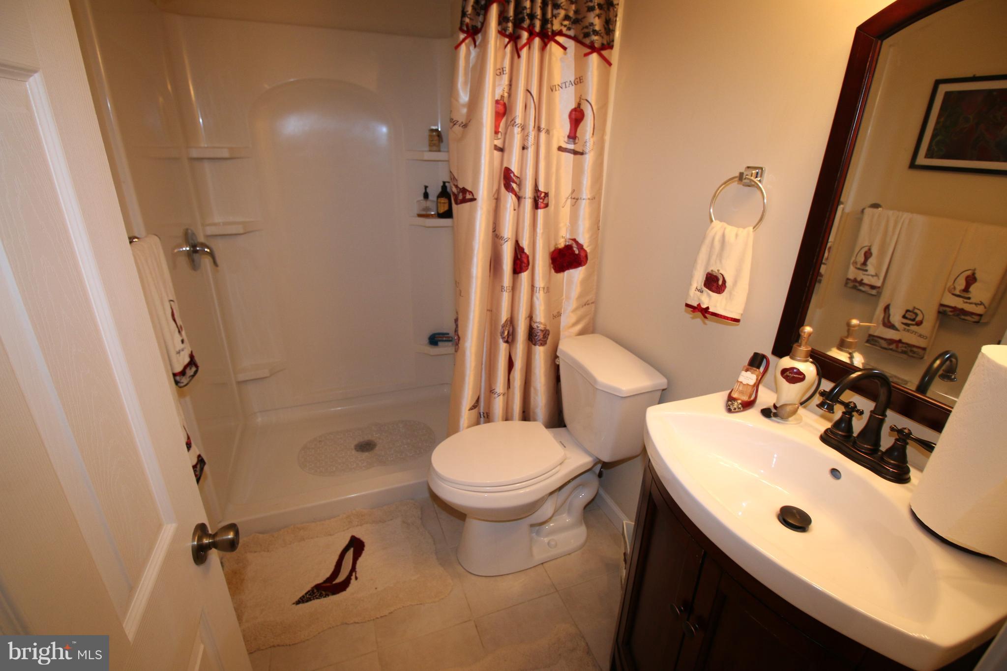 512 Old Riverside Road Baltimore, MD 21225 - Photo 32 of 38 a bathroom with a sink toilet and shower