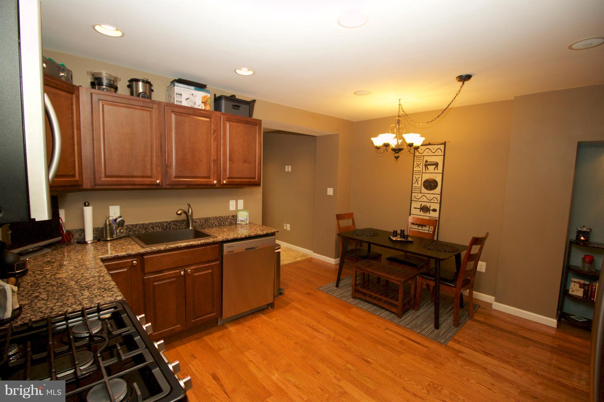 512 Old Riverside Road Baltimore, MD 21225 - Photo 9 of 38 a kitchen with granite countertop a sink cabinets and wooden floor
