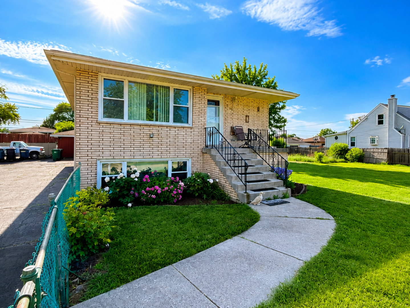 8356 South 78th Avenue Bridgeview, IL 60455 - Photo 2 of 39 a front view of a house with a garden and plants
