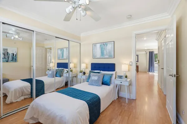 a spacious bedroom with two beds and a chandelier