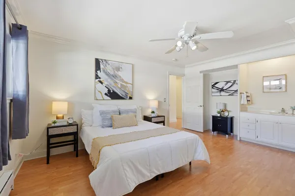 a bedroom with a bed and a chandelier