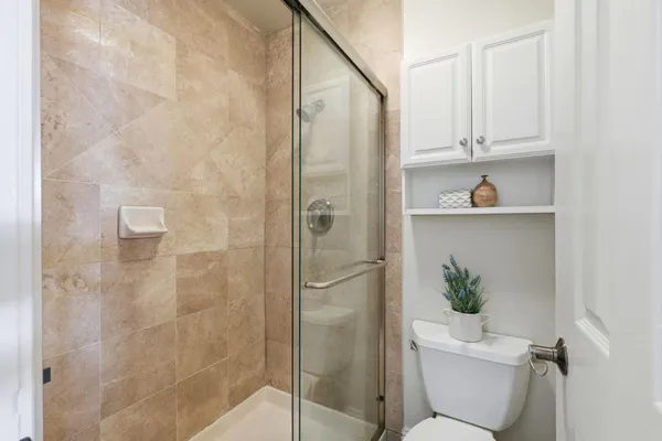 a bathroom with a shower a toilet and a sink