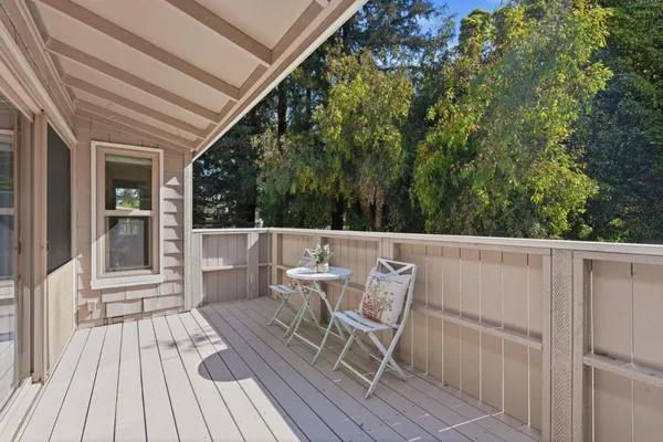 a view of deck with table and chairs and wooden floor
