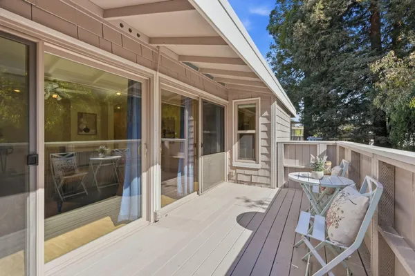 a view of deck with furniture and garden