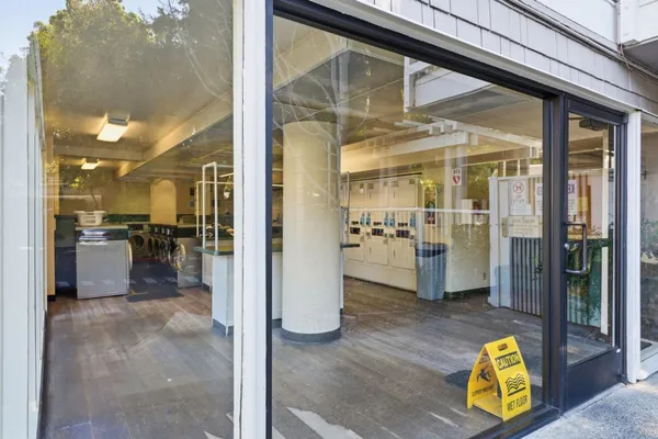 a view of living room kitchen and entryway