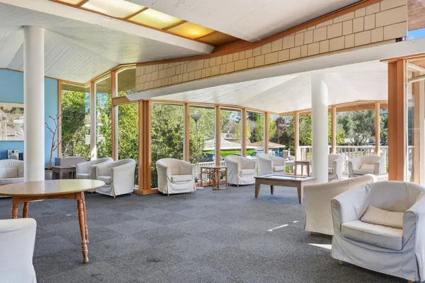a living room with furniture and floor to ceiling windows