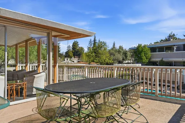 a view of a chair and table on the deck