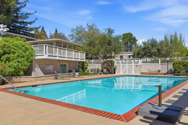 swimming pool view with a outdoor seating