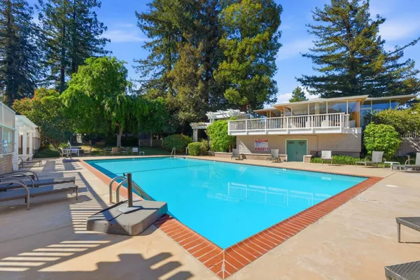 a view of a swimming pool with a lounge chair