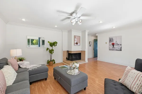 a living room with furniture and a chandelier
