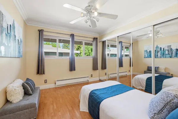 a bedroom with two beds and a large window