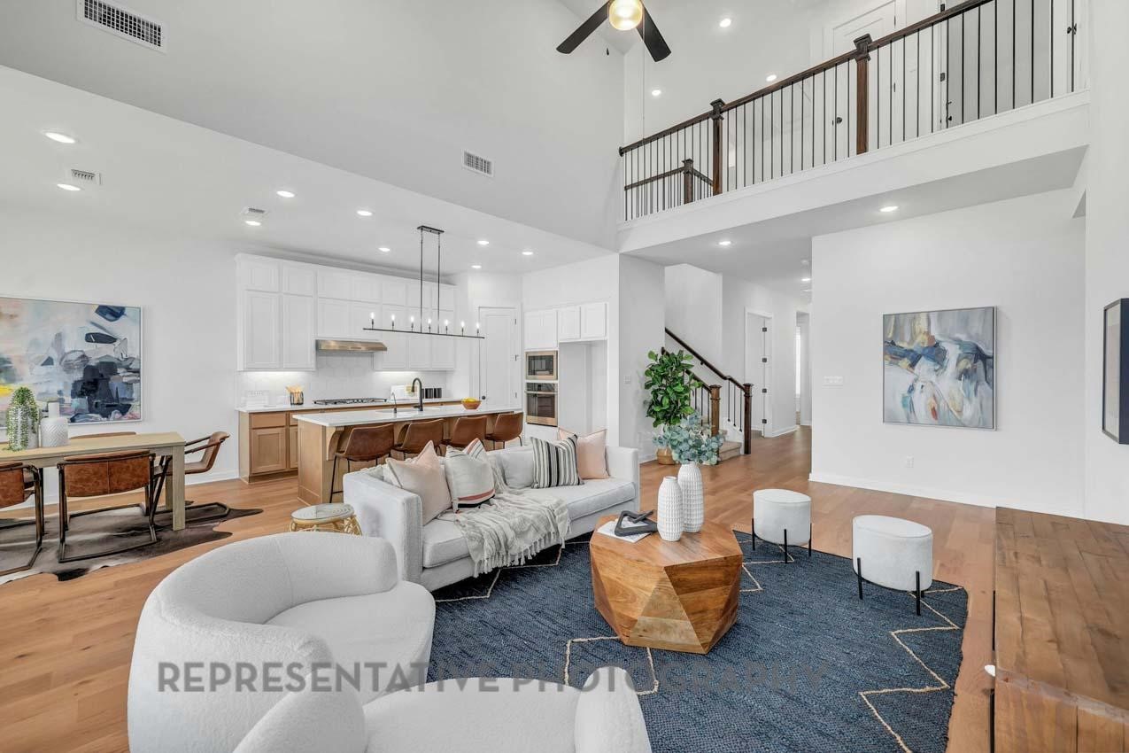 2719 Russell Meadows Lane Fulshear, TX 77423 - Photo 6 of 23 a living room with furniture kitchen view and a chandelier
